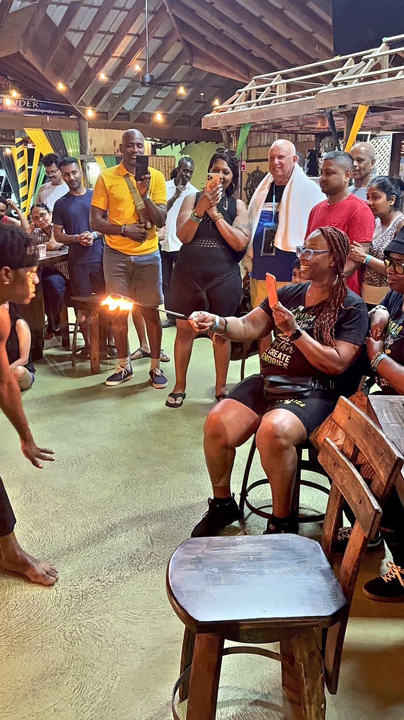 A guest joining a fire performance during a cultural evening